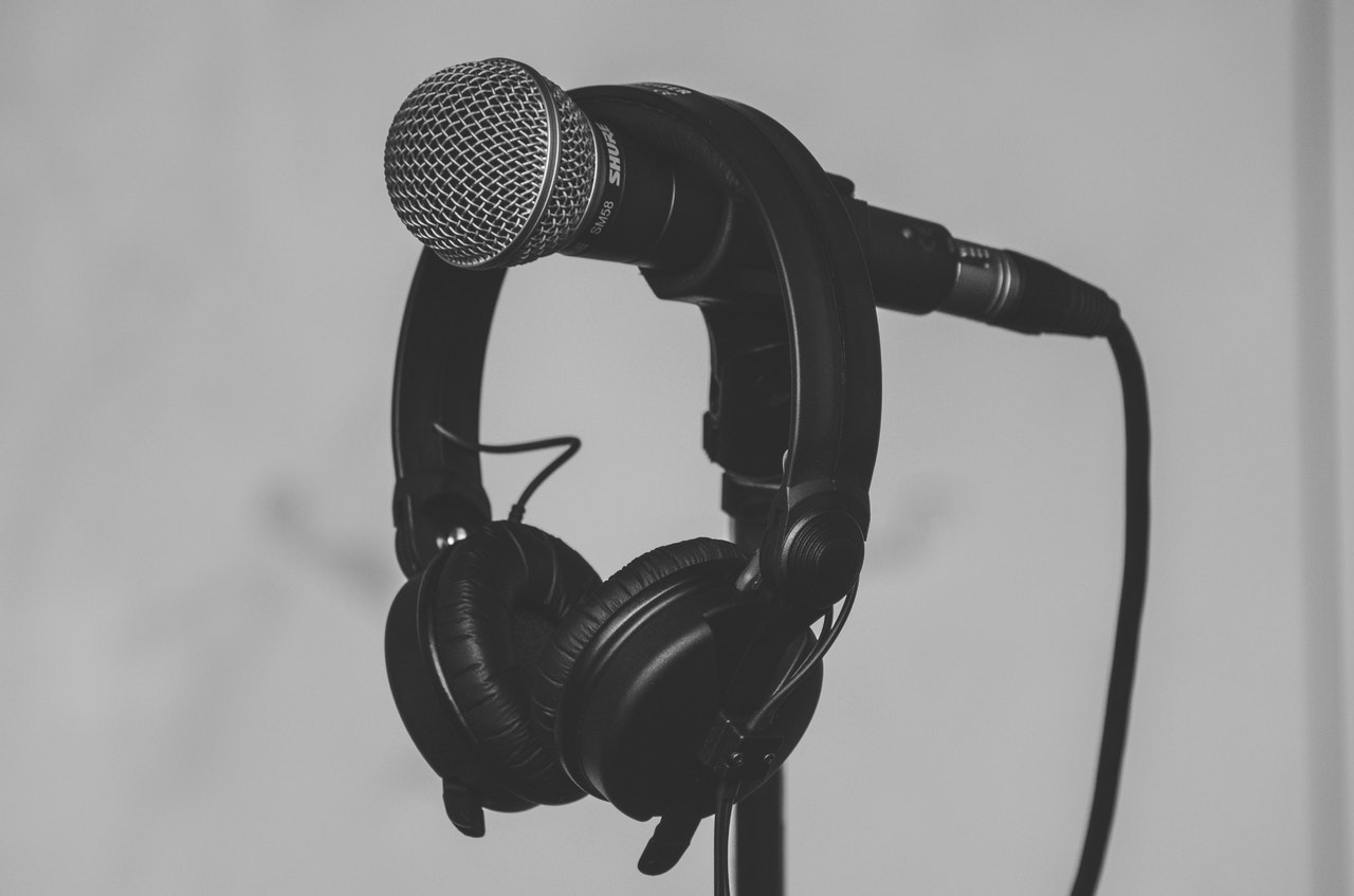 A pair of headphones hanging on a microphone